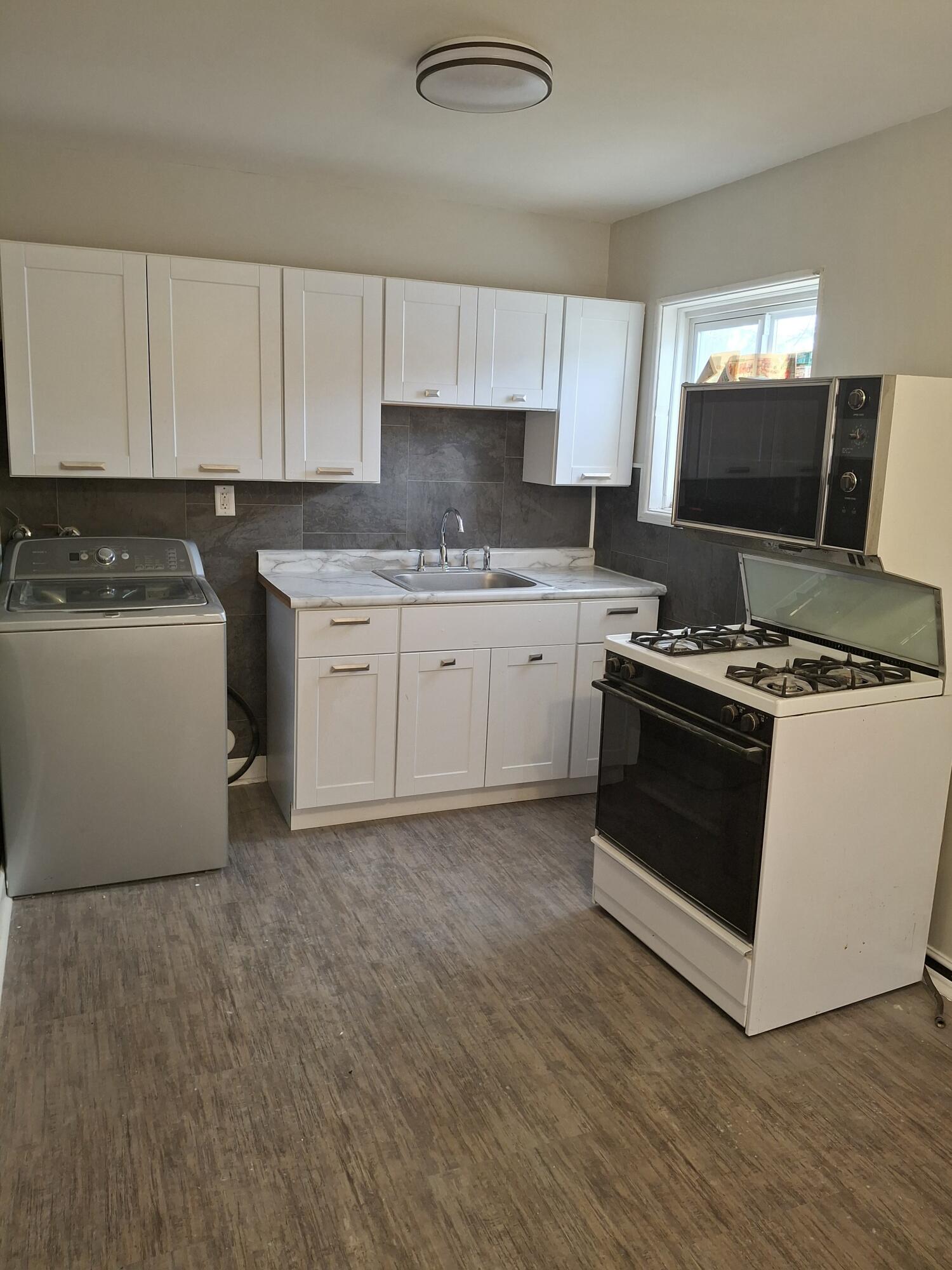 1962 Whitcomb Street Gary, IN 46404 - Photo 4 of 12 a kitchen with granite countertop a sink and a stove top oven