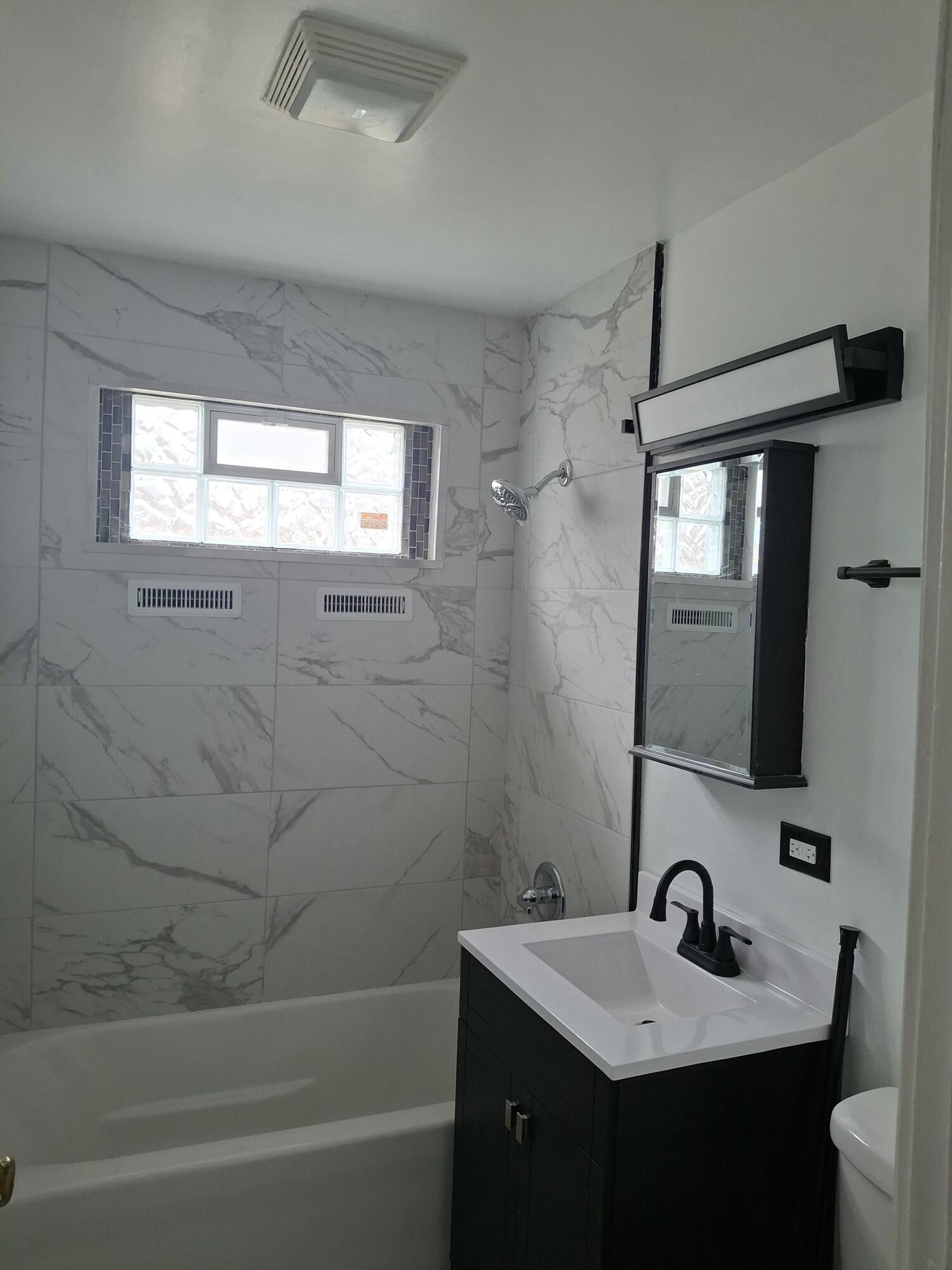 1962 Whitcomb Street Gary, IN 46404 - Photo 7 of 12 a bathroom with a sink a window and a mirror