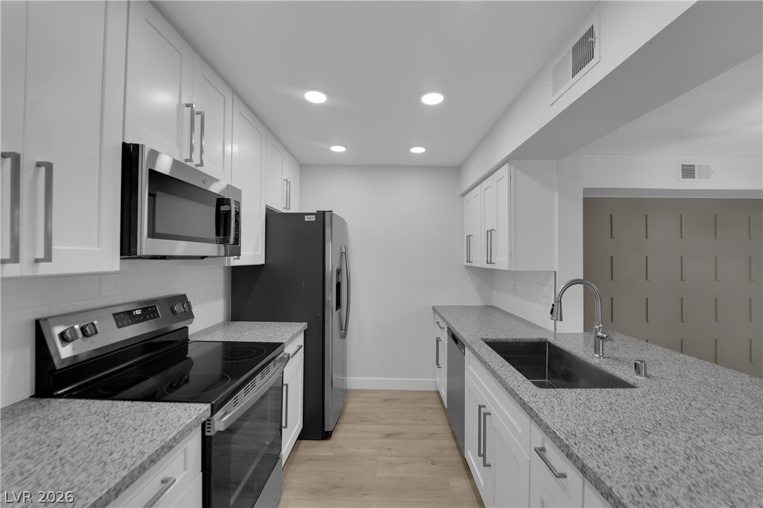 8101 West Flamingo Road, Unit 2152 Las Vegas, NV 89147 - Photo 1 of 45 Streamlined kitchen design with ample storage and modern amenities.