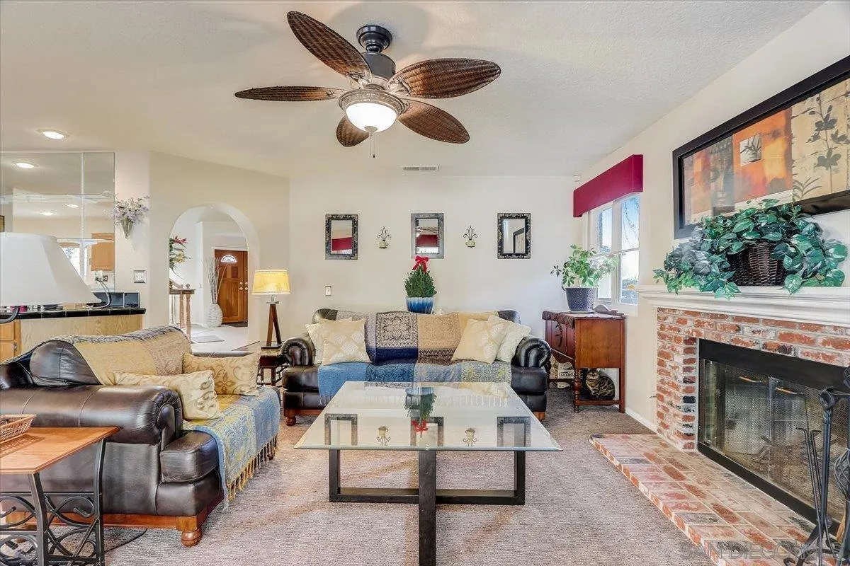 14381 Silver Heights Road Poway, CA 92064 - Photo 15 of 56 a living room with furniture a fireplace and a large window