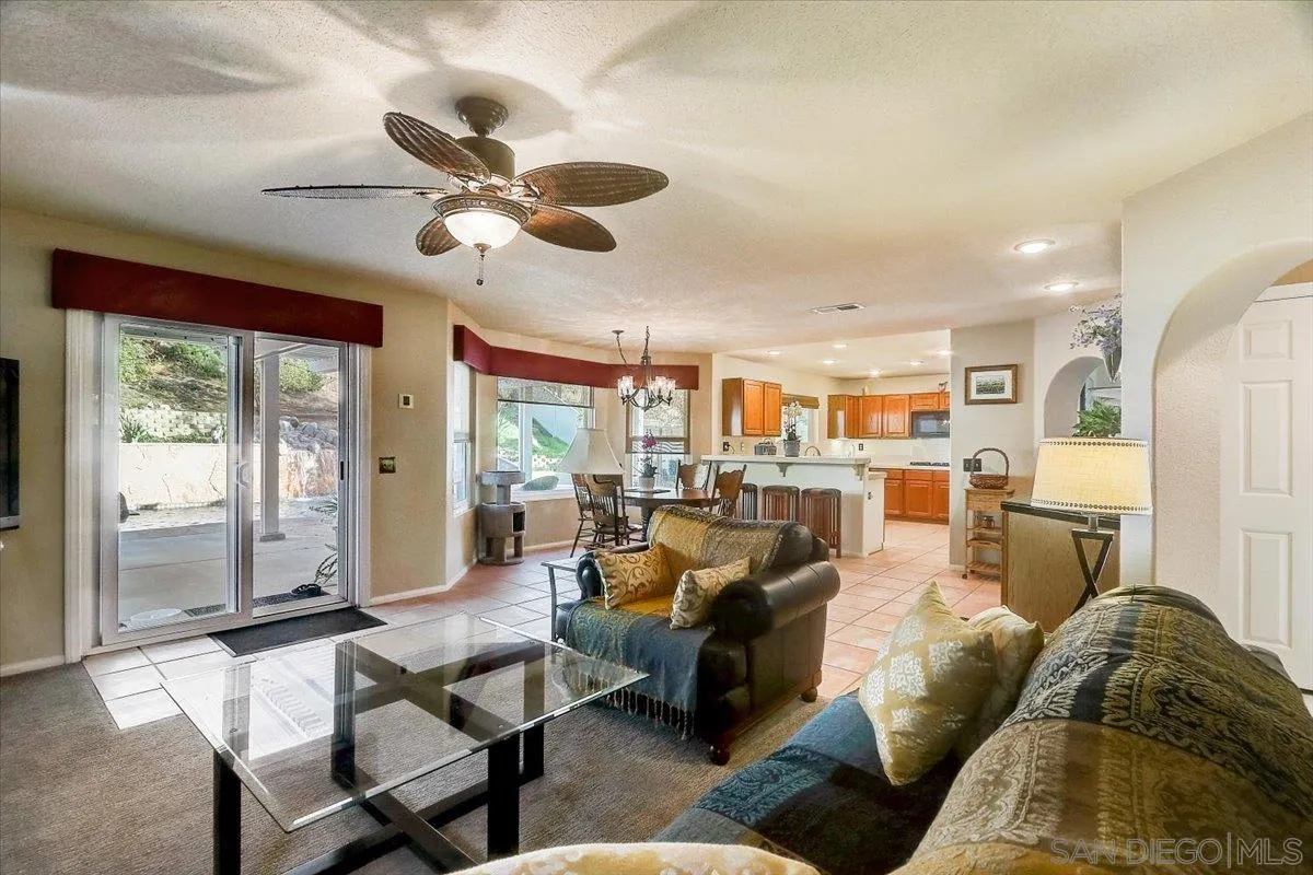 14381 Silver Heights Road Poway, CA 92064 - Photo 17 of 56 a living room with furniture kitchen view and a large window