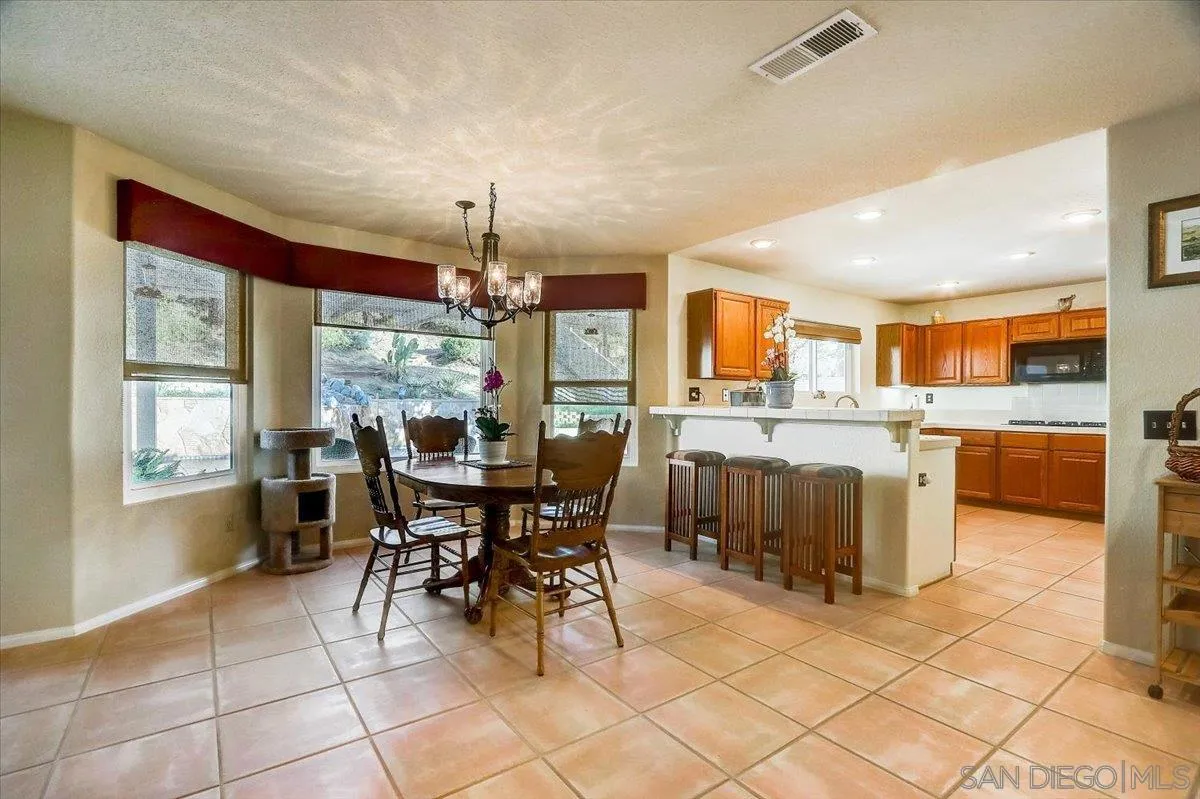 14381 Silver Heights Road Poway, CA 92064 - Photo 19 of 56 a view of a dining room with furniture and chandelier