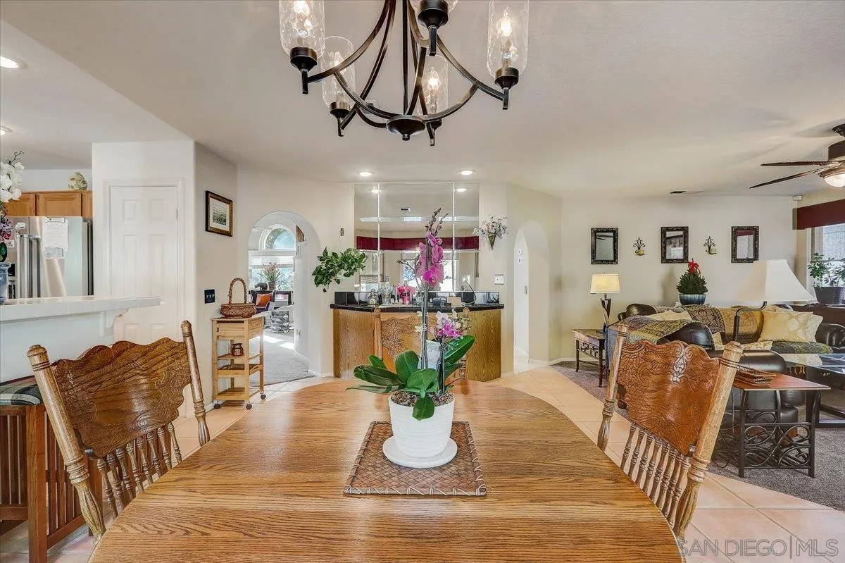 14381 Silver Heights Road Poway, CA 92064 - Photo 21 of 56 a dining room with furniture a chandelier and wooden floor