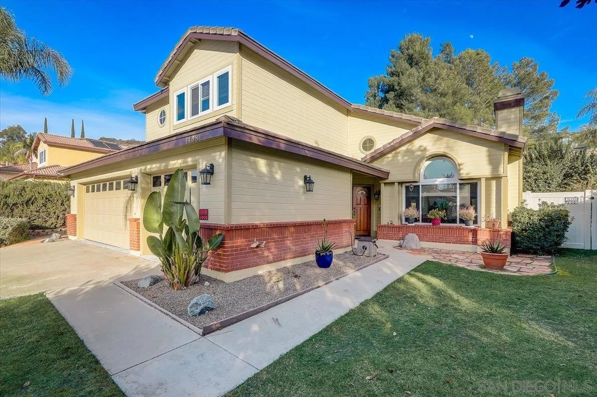 14381 Silver Heights Road Poway, CA 92064 - Photo 3 of 56 a front view of a house with a yard and porch