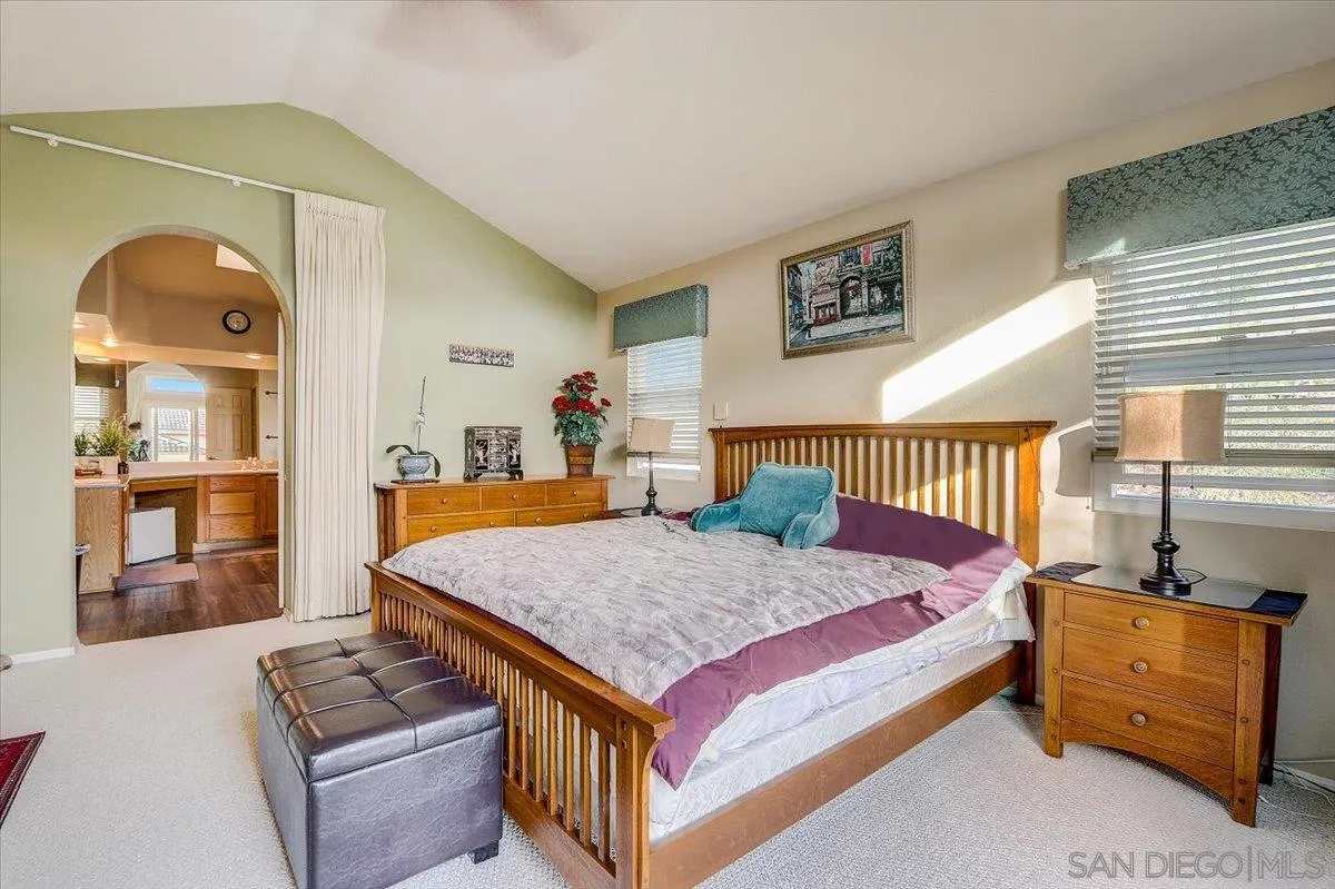 14381 Silver Heights Road Poway, CA 92064 - Photo 32 of 56 a bedroom with a bed and dresser with mirror