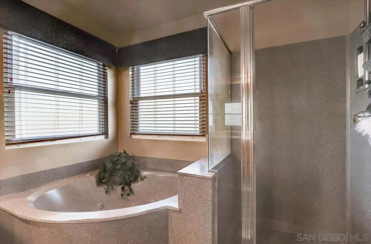 14381 Silver Heights Road Poway, CA 92064 - Photo 34 of 56 a bathroom with a bathtub and a window