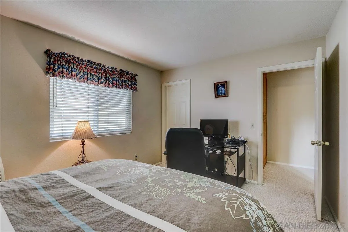 14381 Silver Heights Road Poway, CA 92064 - Photo 36 of 56 a bedroom with a bed and a computer on table