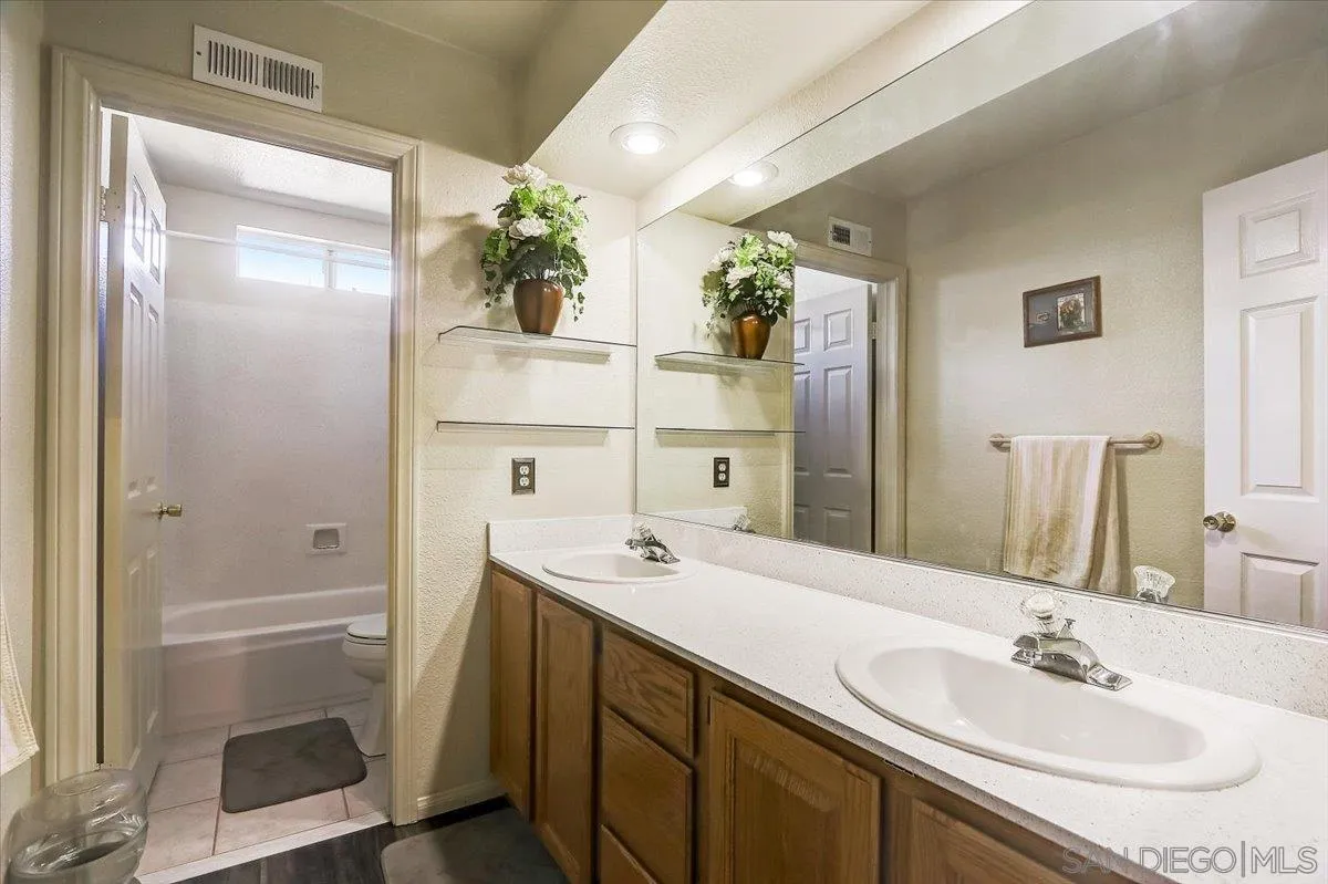 14381 Silver Heights Road Poway, CA 92064 - Photo 37 of 56 a bathroom with a sink and a mirror