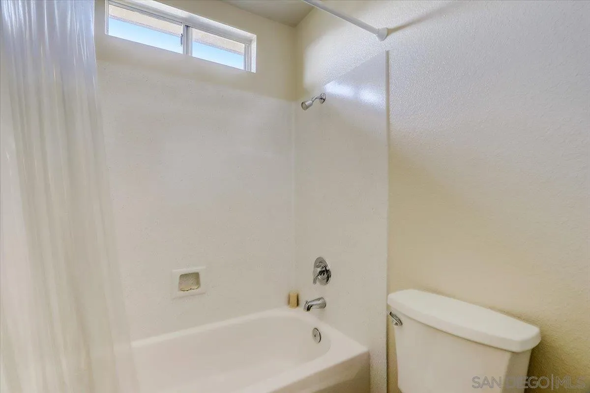 14381 Silver Heights Road Poway, CA 92064 - Photo 38 of 56 a white bath tub sitting next to a white toilet