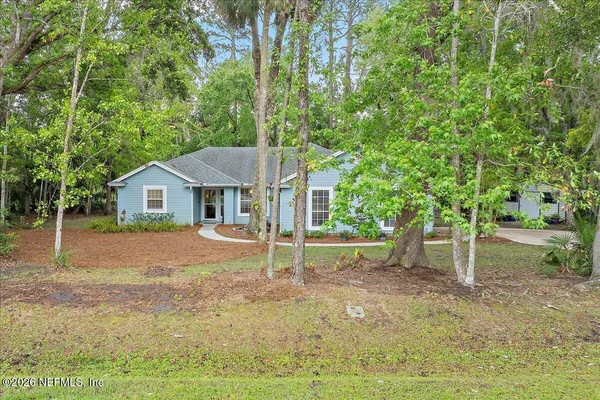 a house that has a tree in front of it