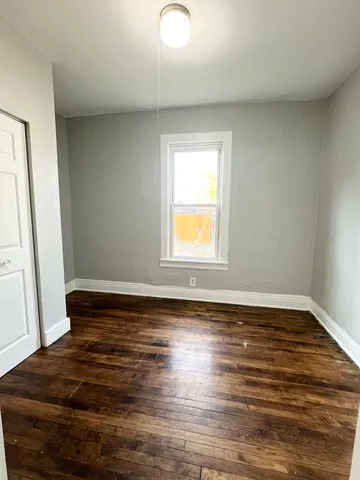 a view of an empty room and wooden floor