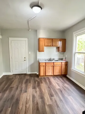 a kitchen with granite countertop a sink and a stove top oven