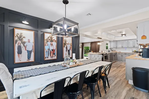 a view of a dining room with furniture wooden floor and chandelier