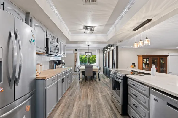a kitchen with kitchen island granite countertop lots of counter top space and stainless steel appliances