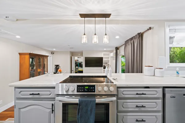 a kitchen with a stove and a white cabinets