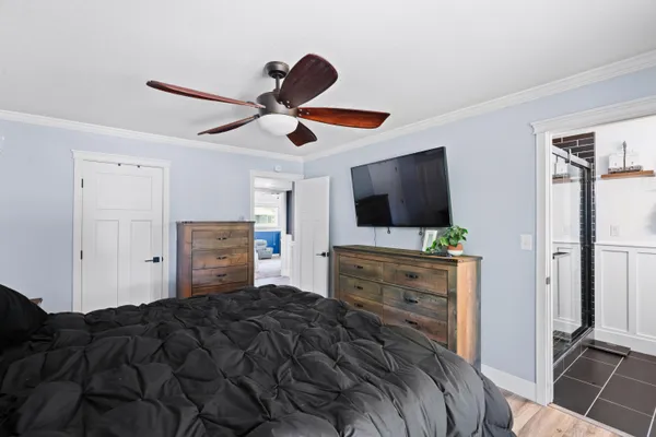 a bedroom with a bed and a flat screen tv