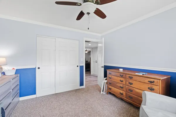 a view of room with closet and ceiling fan