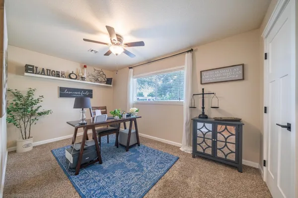 a work room with furniture and a chandelier