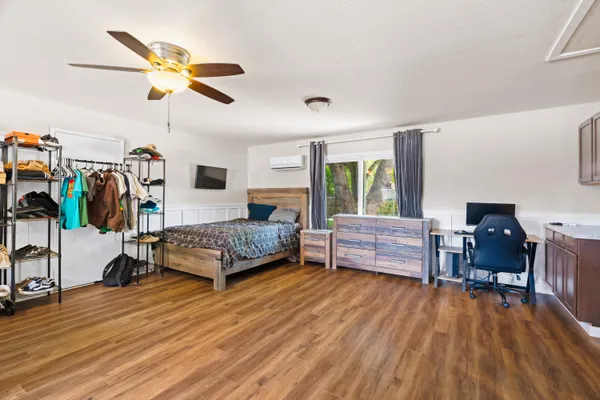 a living room with furniture and a wooden floor