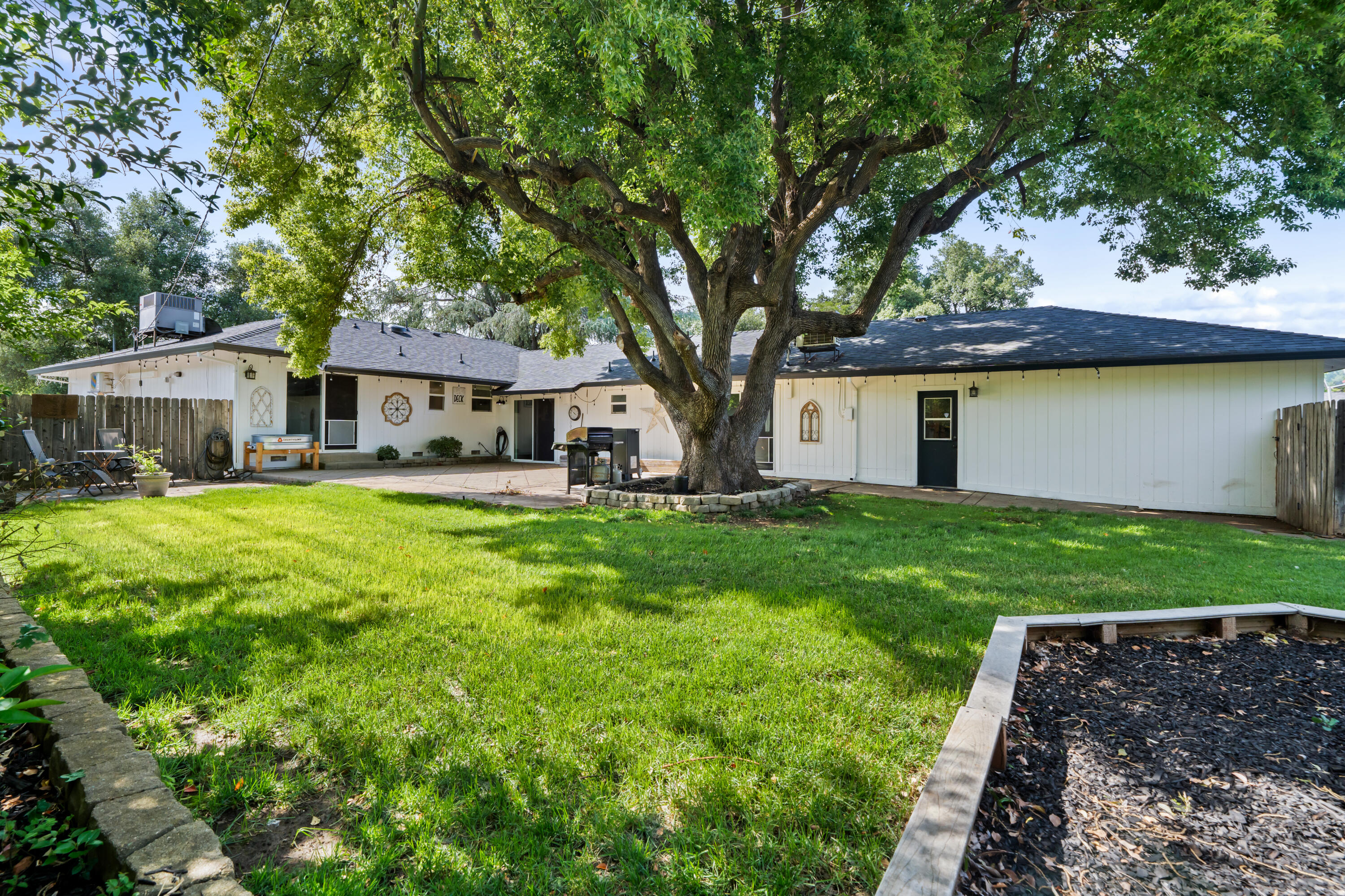 3689 Suzanne Way Redding, CA 96002 - Photo 43 of 46 a front view of a house with a yard and trees