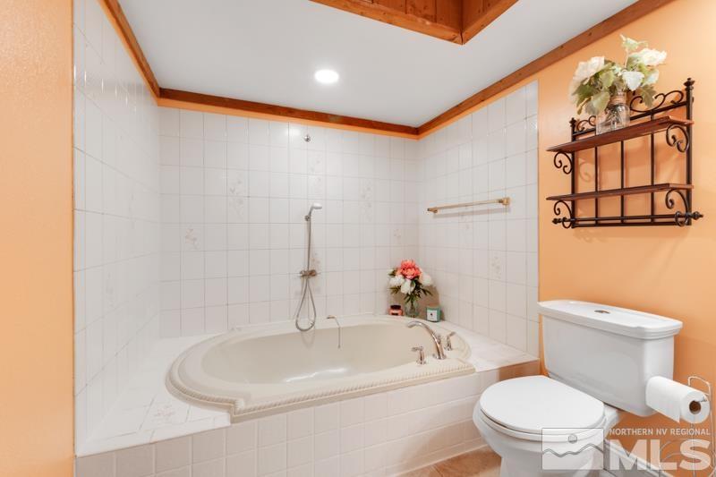 60 Rodeo Drive Reno, NV 89508 - Photo 12 of 37 a white toilet sitting next to a bathroom sink and tub