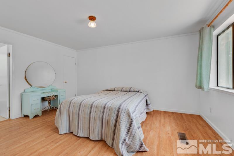 60 Rodeo Drive Reno, NV 89508 - Photo 14 of 37 a bedroom with a bed and wooden floor