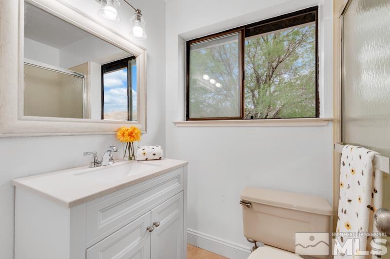 60 Rodeo Drive Reno, NV 89508 - Photo 16 of 37 a bathroom with a sink vanity mirror and toilet