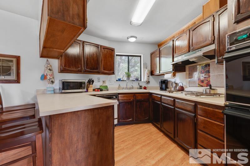 60 Rodeo Drive Reno, NV 89508 - Photo 10 of 37 a kitchen with cabinets a sink and appliances