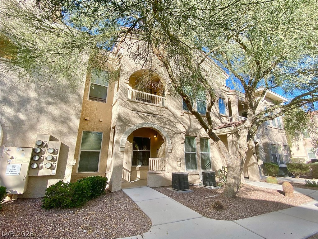 A graceful multi-level building façade with arched entryways and a charming upper balcony.