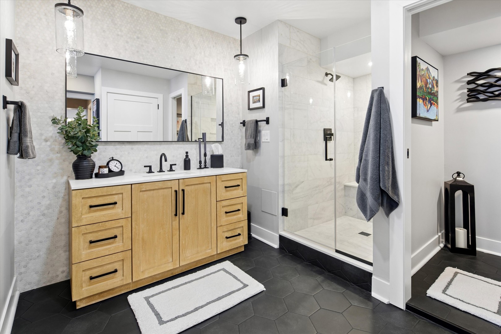 175 East Delaware Place, Unit 7304 Chicago, IL 60611 - Photo 17 of 36 a bathroom with a double vanity sink a mirror a glass door a shower and a mirror