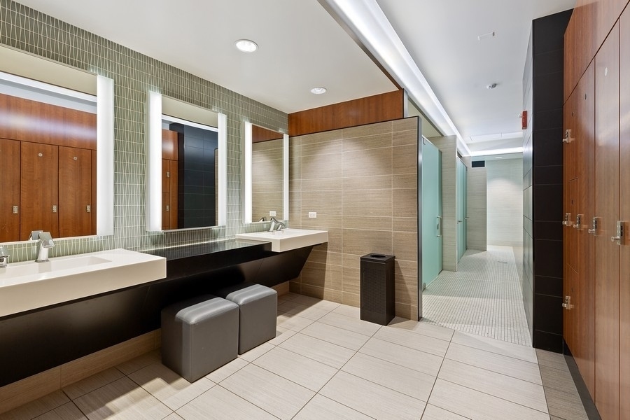 175 East Delaware Place, Unit 7304 Chicago, IL 60611 - Photo 28 of 36 a bathroom with a double vanity sink a toilet and a mirror