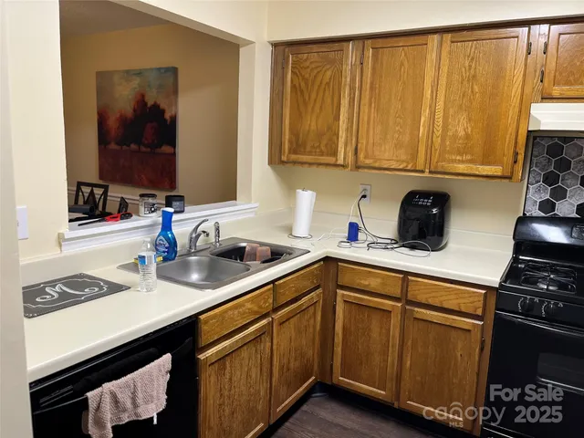 a kitchen with a sink cabinets and appliances
