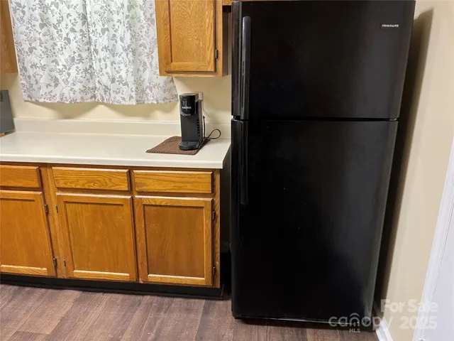 a kitchen with a refrigerator and cabinets