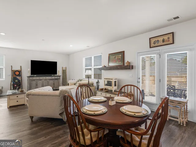 a view of a dining room with furniture and a flat screen tv