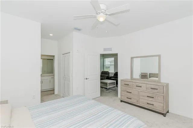 a view of room with cabinet and ceiling fan