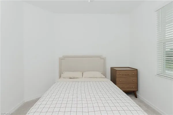 a bedroom with a bed and a rug