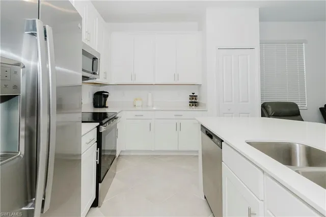 a kitchen with a sink and refrigerator