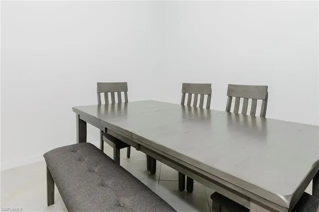 a kitchen with a table chairs and wooden floor