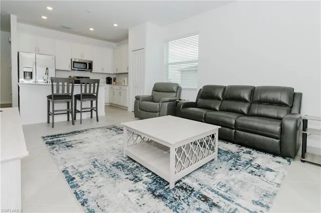 a living room with furniture and a rug