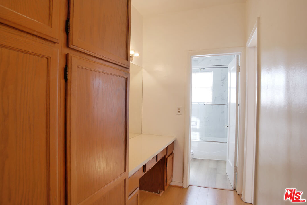 611 South Cloverdale Avenue, Unit 305 Los Angeles, CA 90036 - Photo 16 of 18 a bathroom with a shower and a glass door