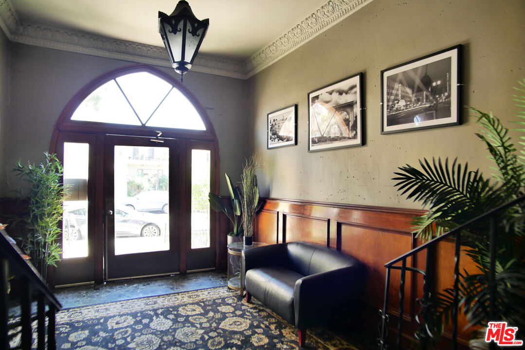 611 South Cloverdale Avenue, Unit 305 Los Angeles, CA 90036 - Photo 5 of 18 a bedroom with furniture and a window