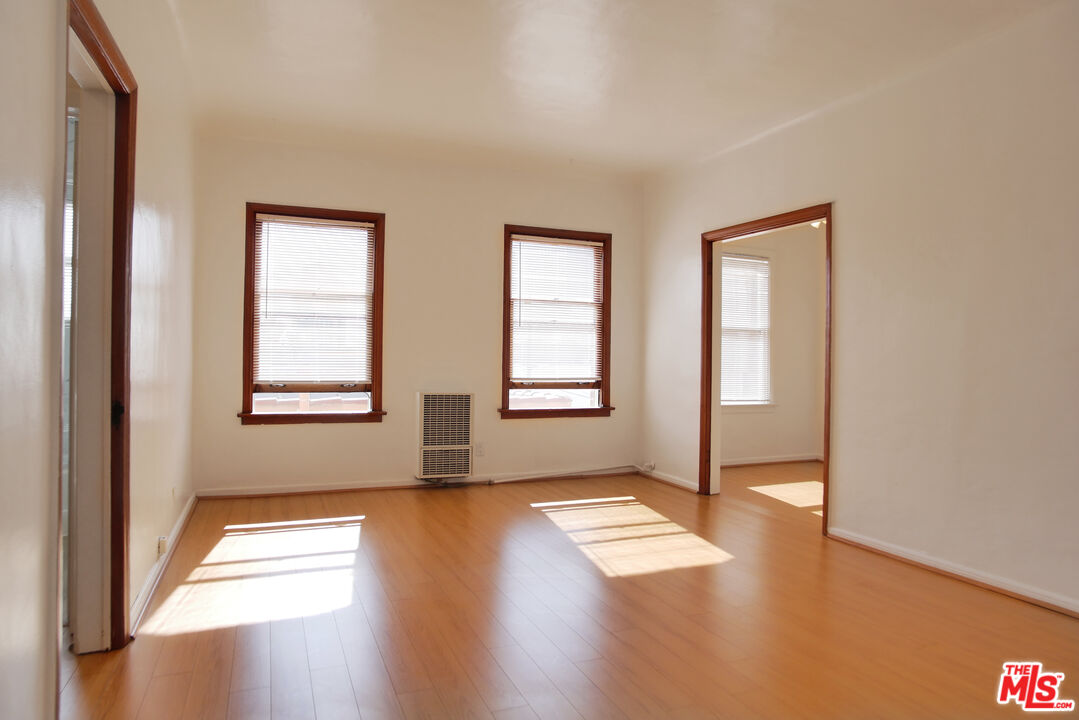 611 South Cloverdale Avenue, Unit 305 Los Angeles, CA 90036 - Photo 9 of 18 a view of empty room with wooden floor and fan