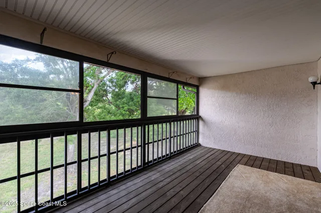 a view of hallway with wooden floor