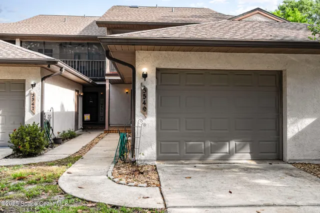 a view of a house with potted plants