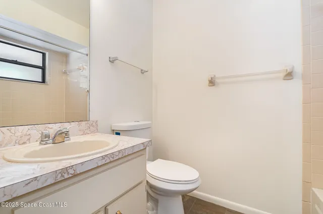 a bathroom with a sink toilet and a mirror