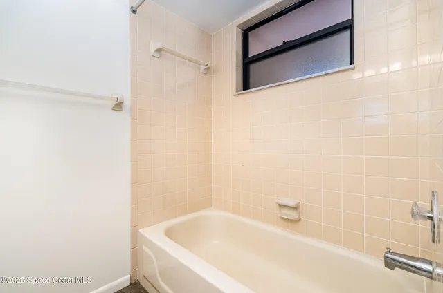 a bathroom with a tub and a shower