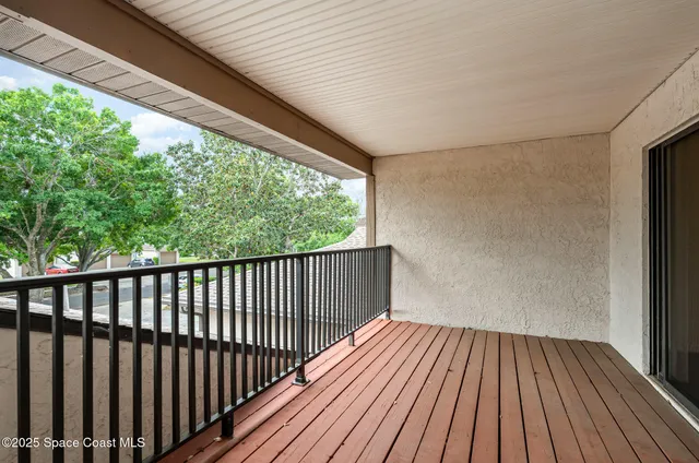 a view of a balcony with wooden floor