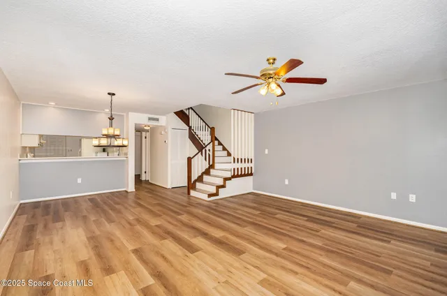 a view of a kitchen with a sink and a chandelier fan