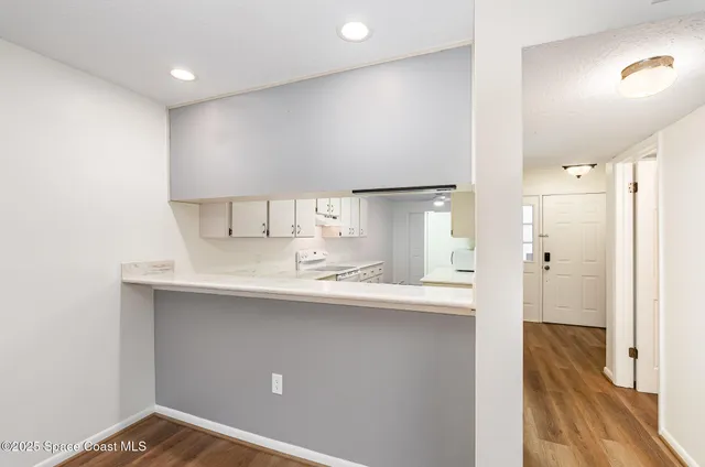 a kitchen with kitchen island a sink stainless steel appliances and cabinets