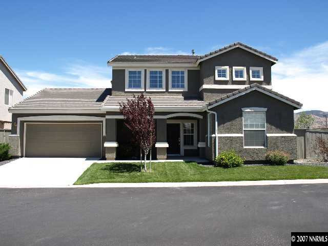 10532 Iron Point Circle Reno, NV 89521 - Photo 1 of 6 a front view of a house with a garden and yard